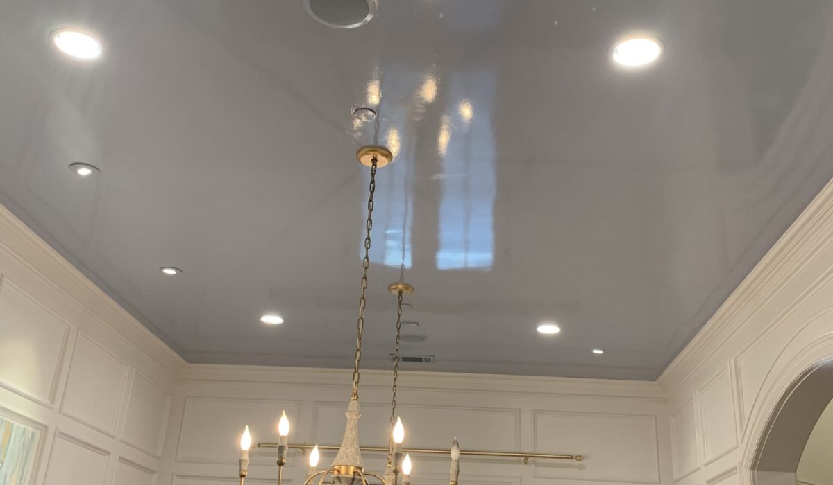 High-gloss lacquered ceiling installation in a tall vaulted entryway